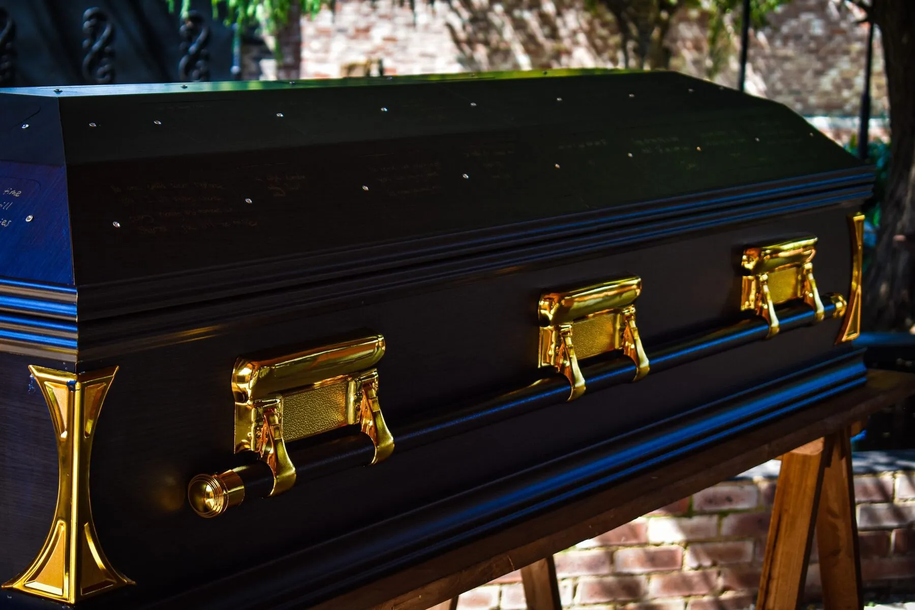 Close-up of handwritten farewell messages on a Final Words casket lid