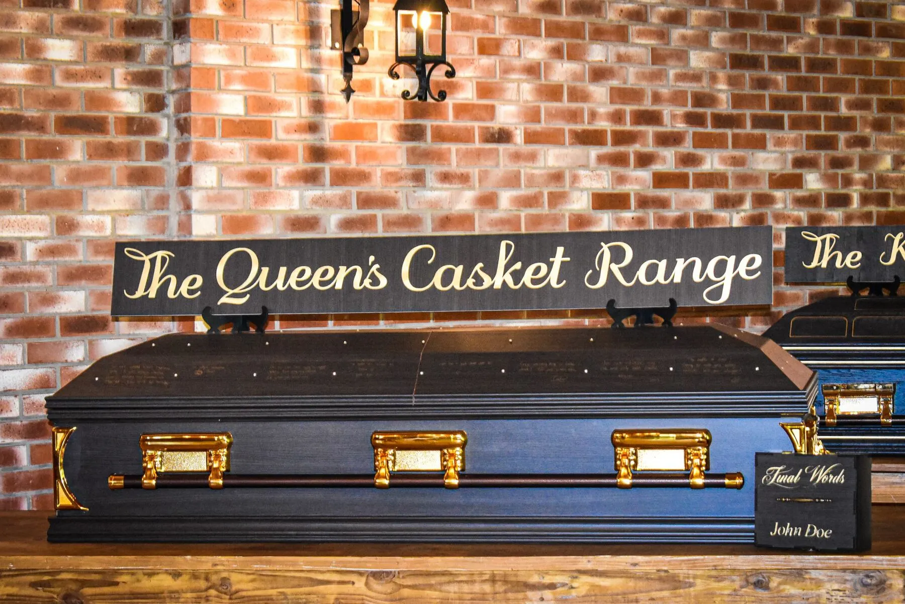 The Queen's Casket Range in dark finish with gold hardware